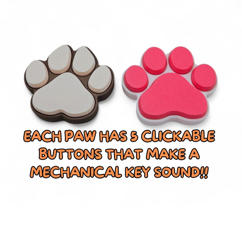 May include: Two paw-shaped clicker toys, one in gray and brown, the other in pink and white. Each paw has five clickable buttons that make a mechanical key sound. The toys are designed to resemble a pet's paw print.