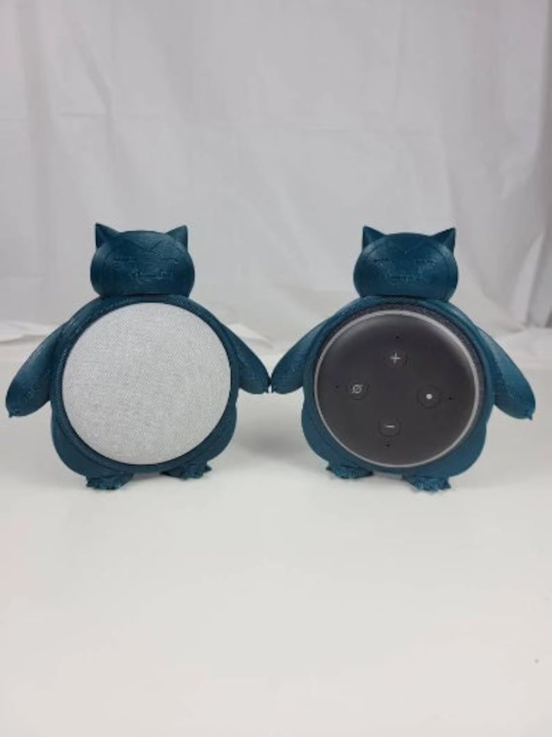 May include: Two teal blue 3D printed Snorlax figures, each with a different speaker inside. One speaker is white and the other is black.