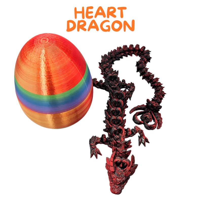 May include: A red heart-shaped dragon toy with a rainbow-colored egg. The text "HEART DRAGON" is written above the egg.