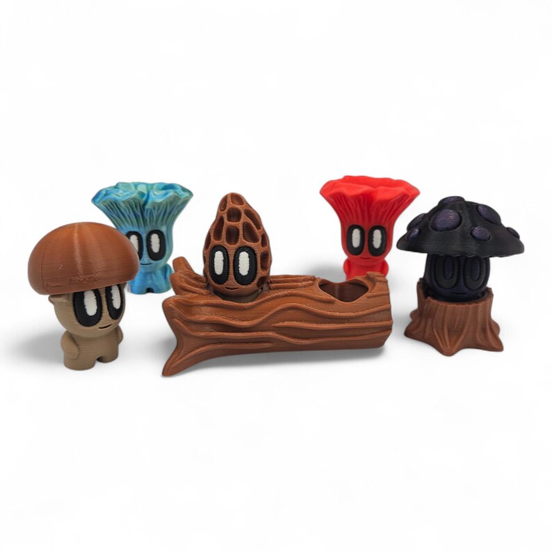 May include: A collection of whimsical mushroom figurines in various colors, including brown, blue, red, and black. Each figurine has a unique design, with stylized faces and details. One figurine is nestled in a brown log.
