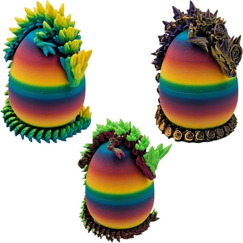 May include: Three rainbow-coloured eggs with dragon-like figures sculpted around them. The dragons are green, purple and gold.