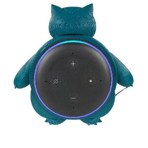 May include: Teal blue 3D printed stand shaped like a cartoon creature with a black smart speaker inside.