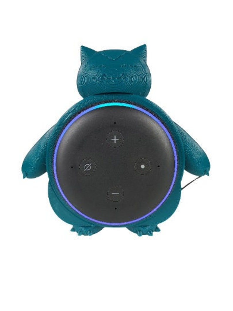 May include: Teal blue 3D printed stand shaped like a cartoon creature with a black smart speaker inside.