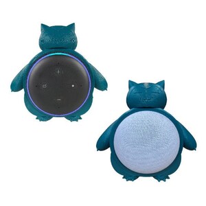May include: A teal blue 3D printed wall mount for an Amazon Echo Dot smart speaker. The mount is shaped like a Pokemon character, Snorlax, with a round opening for the speaker.