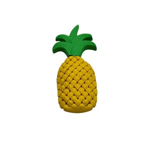 May include: A yellow pineapple with a green leafy top. The pineapple has a textured surface, and the leaves are a vibrant green. The fruit is a bright, cheerful design, perfect for tropical-themed decor.