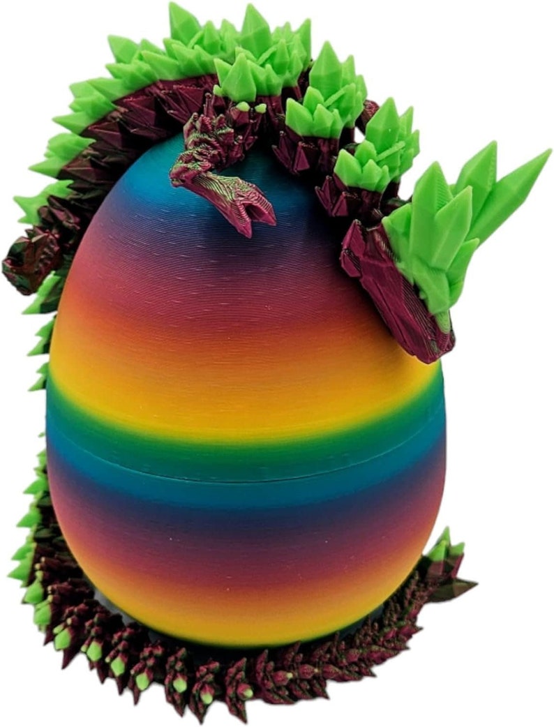 May include: A rainbow-coloured egg with a green and purple dragon emerging from the top. The dragon has a spiky, textured body.