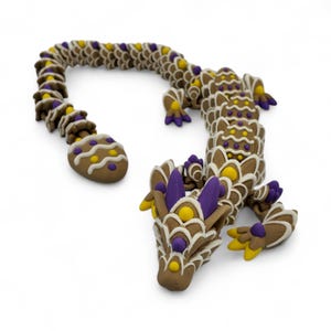 May include: A brown, dragon-shaped sculpture with intricate details. The dragon features a segmented body, with purple, yellow, and white accents. The sculpture has a detailed head, legs, and tail, and is set against a white background.