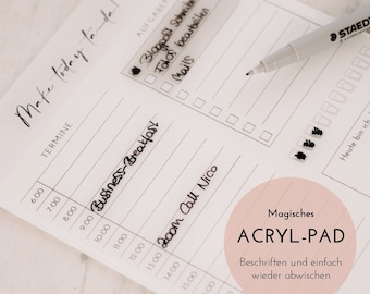 May include: A white dry-erase planner with a black marker and the text "Make today ta-da!" and "Magisches ACRYLPAD" with the text "Beschriften und einfach wieder abwischen".