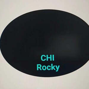 May include: A black oval shape with the words "CHI Rocky" in teal. The background is a light gray color.