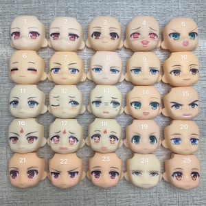 May include: Twenty-five different doll face plates with various expressions, including happy, sad, angry, and surprised. The face plates are numbered 1 through 25.