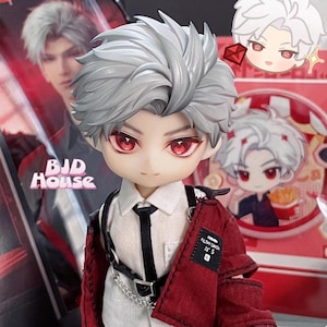 May include: A white-haired doll with red eyes wearing a white shirt, black tie, and a red jacket. The doll is wearing a black belt with a silver chain. The doll is standing in front of a red and white background with the text "BJD HOUSE" on it.