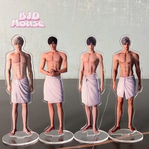 May include: Four acrylic stand-up figures of men wearing white towels. The figures are posed in different stances and have different hairstyles. The figures are on clear acrylic bases.