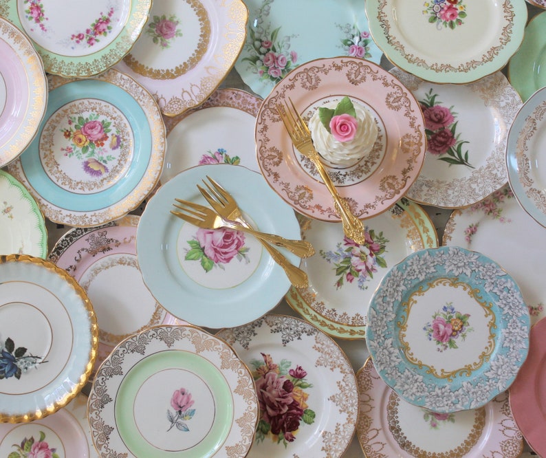 Vintage mismatched dishes in a variety of sizes. Mostly floral patterns in pastel colors with gold or silver trim. Fancy china dishes used for parties and entertaining but often used for plate walls and cottage chic home decor. Mix and Match Plates