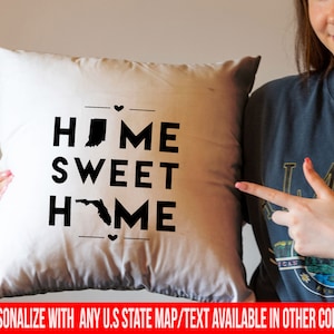 May include: White throw pillow with black text that reads "HOME SWEET HOME" and features an outline of Indiana and Florida.  The text is available in other colors and can be personalized with any U.S. state map.