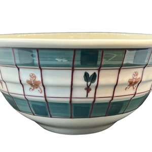 May include: A white ceramic mixing bowl with a green and red plaid pattern and gingerbread man and holly designs.
