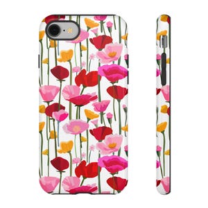 May include: A white iPhone case with a floral pattern featuring pink, red, and yellow poppies. The case has a black border.
