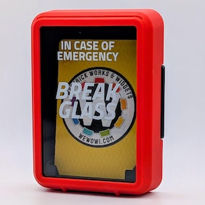 Könnte beinhalten: Ein roter rechteckiger Kasten mit schwarzem Innenraum und klarer Front. Der Text "IN CASE OF EMERGENCY" und "BREAK GLASS" ist auf gelbem Hintergrund zu sehen. Der Kasten hat einen schwarzen Riegel an der Seite.