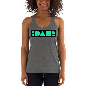 May include: A gray racerback tank top with a black rectangle across the chest. The rectangle contains the word "IDAHO" in white letters with a turquoise circle, triangle, and square in the middle of the letters.