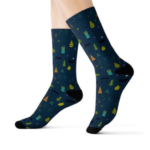 May include: A pair of blue socks with a colorful pattern of trees and camping tents. The socks are made of a soft, comfortable material and are perfect for everyday wear.