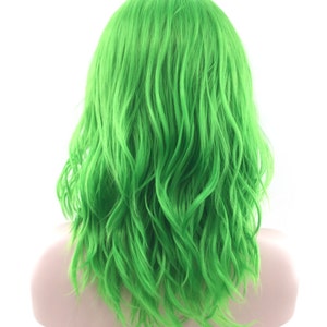 May include: A bright green wig with wavy, shoulder-length hair. The wig is styled in a casual, tousled look.