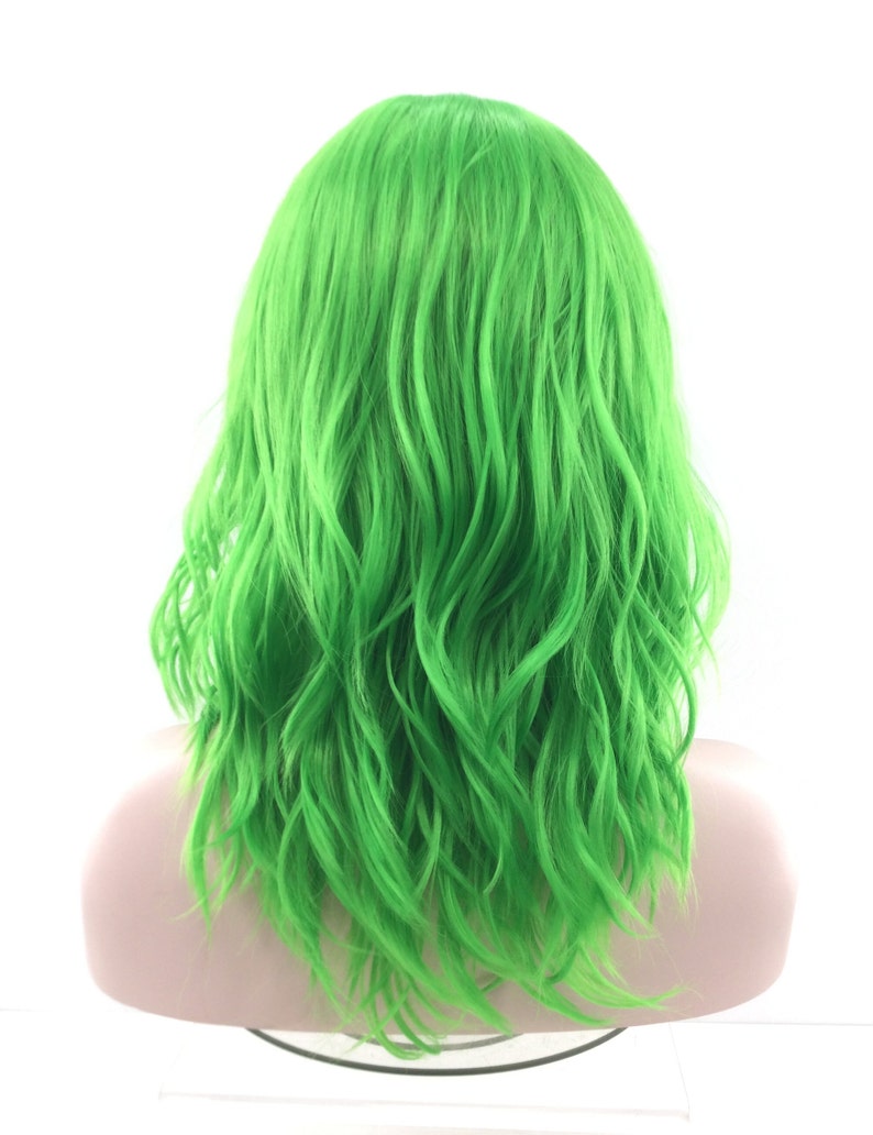 May include: A bright green wig with wavy, shoulder-length hair. The wig is styled in a casual, tousled look.