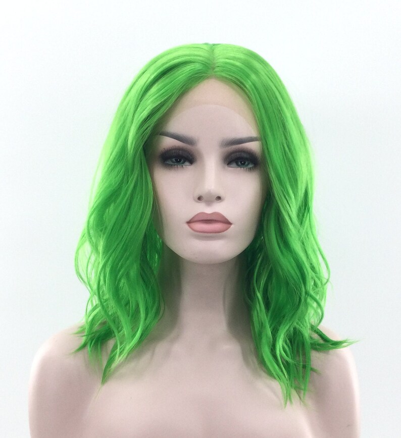 May include: A bright green, wavy, shoulder-length synthetic wig with a lace front.