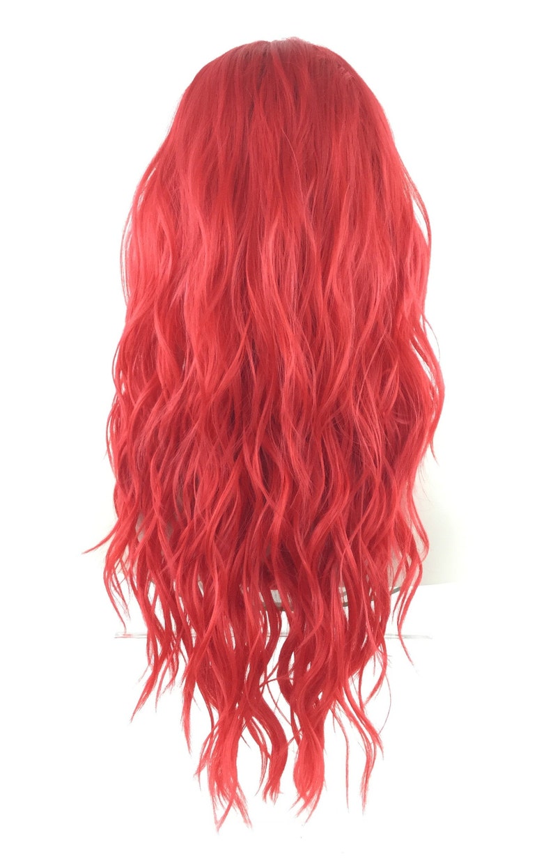 May include: A long, wavy, bright red wig. The wig is styled with loose, flowing curls.