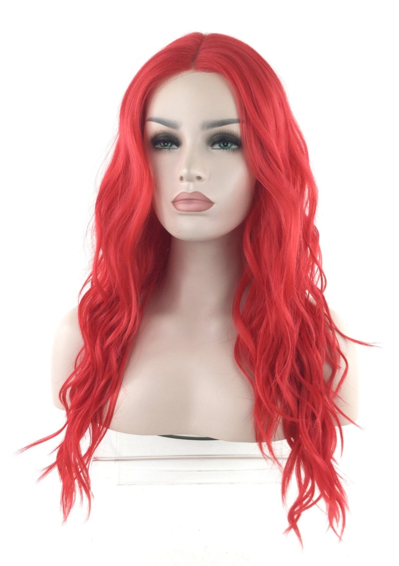 May include: A long, wavy, bright red wig with a lace front. The wig is styled in loose waves and falls to the shoulders.