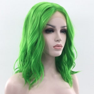 May include: A bright green, wavy synthetic wig with a lace front. The wig is styled in a shoulder-length bob.