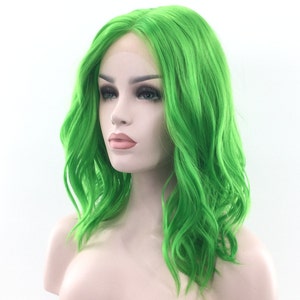 May include: A bright green, wavy synthetic wig with a lace front. The wig is styled in a shoulder-length bob with loose waves.