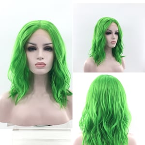 May include: A bright green wavy synthetic wig with a lace front. The wig is styled in a shoulder-length bob.