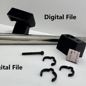 May include: A set of black metal brackets, a silver metal rod, three black plastic clips, and a black screw. The brackets have adhesive pads attached to them. The text "Digital File" appears twice in the image.