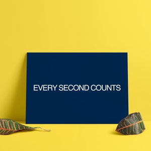 May include: A dark blue card with the text "EVERY SECOND COUNTS" in white on a yellow background with two green and red leaves on either side of the card.