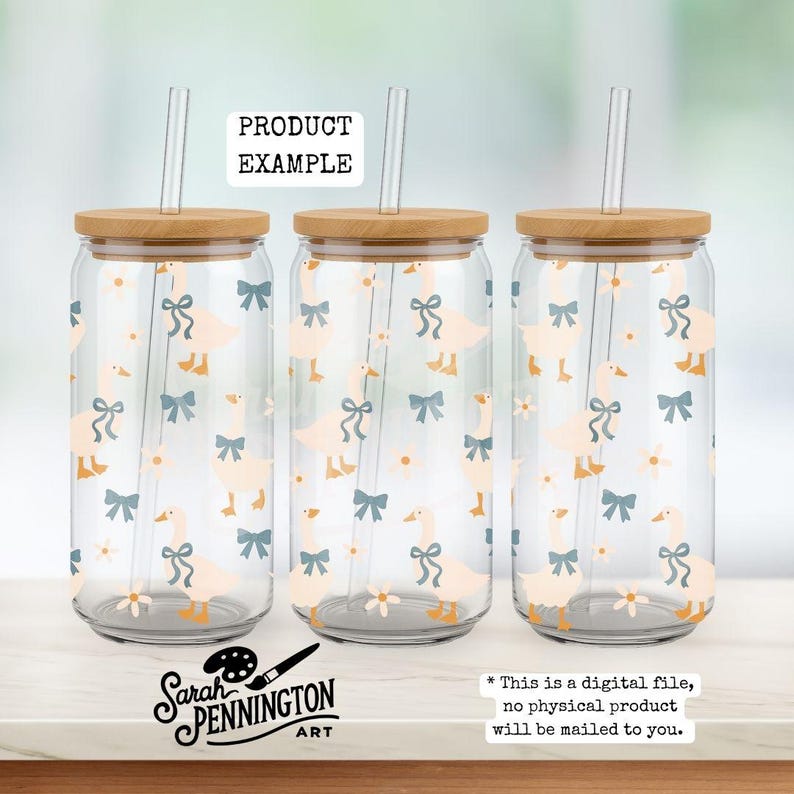 May include: Three clear glass beverage cups with bamboo lids and straws. The cups are decorated with a pattern of light orange geese and blue bows. The text "PRODUCT EXAMPLE" is at the top. The artist's logo and text are at the bottom.