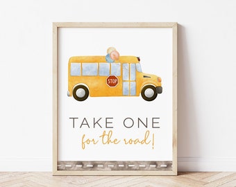 Op de afbeelding: Een gele schoolbus met een stopteken en twee kinderen erin. De bus staat op een witte achtergrond met de tekst "TAKE ONE for the road!" eronder.
