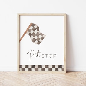 May include: A framed print with a watercolor illustration of a checkered racing flag and the text "Pit Stop". The bottom border of the print features a checkered pattern.
