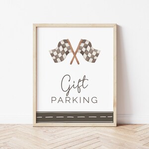 May include: A printable sign with a brown wooden frame. The sign features a watercolor illustration of two checkered racing flags crossed over each other. The text "Gift Parking" is written in black cursive font below the flags. A black and brown dashed line is at the bottom of the sign.