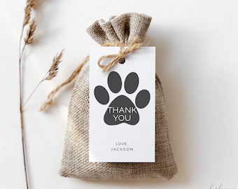 May include: A white gift tag with a black paw print and the text "Thank You" and "Love, Jackson". The tag is tied with twine to a small brown burlap bag.