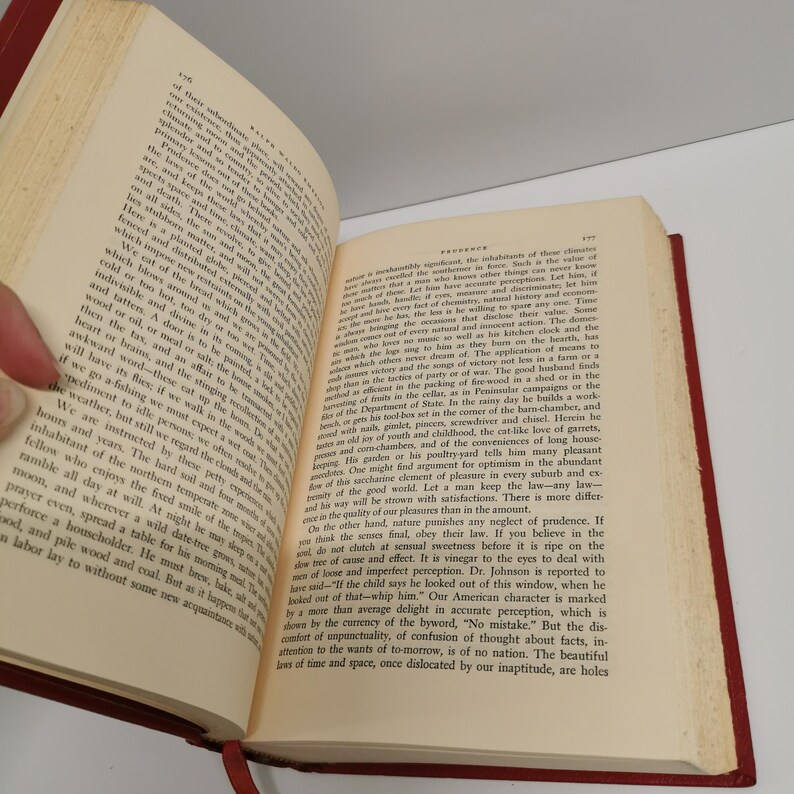 May include: An open book with yellowed pages and a red leather cover. The text on the page discusses the importance of natural and unsentimental action. The book is open to a page with the title "Frivolous".