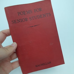 May include: A red book with the title "Poems for Senior Students" and the publisher "Macmillan" printed on the cover.