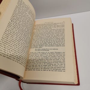 May include: A close-up of a page from a vintage book with text about self-reliance and the importance of not relying on others for help. The text is in a serif font and is printed in black ink on white paper.