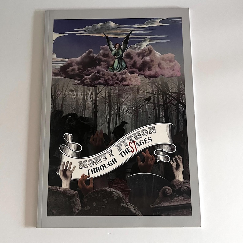 May include: A book cover with a dark, gothic design. The cover features a banner with the text "Monty Python Through The Stages" and an image of a winged figure in a cloud above a forest.