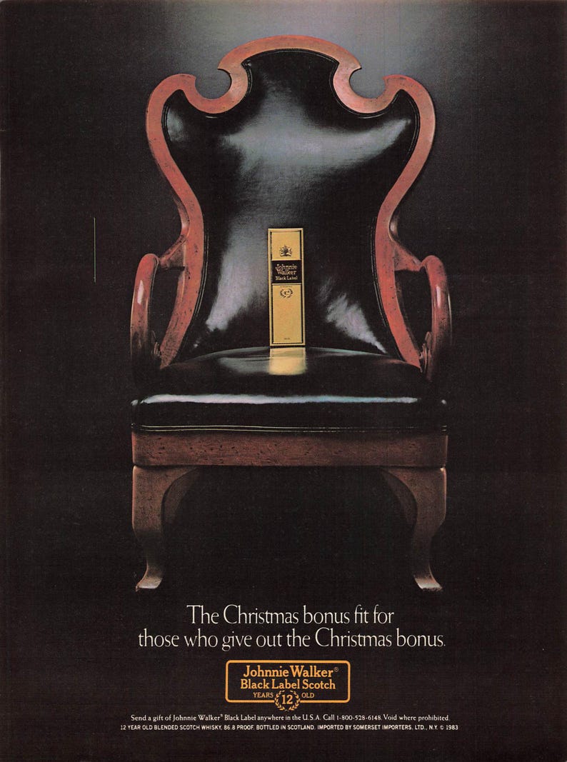 May include: An antique wooden chair with a black leather seat and back, featuring a gold label of Johnnie Walker Black Label Scotch. The chair has a dark wood frame with red accents. Text reads: "The Christmas bonus fit for those who give out the Christmas bonus."