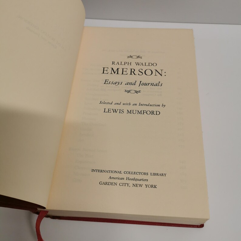 May include: A book titled "Emerson: Essays and Journals" by Ralph Waldo Emerson. The book is selected and with an introduction by Lewis Mumford. It is part of the International Collectors Library, American Headquarters, Garden City, New York.