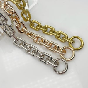 May include: Three chain links in gold, rose gold, and silver with a clasp on each end.