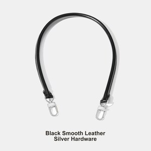 May include: A black smooth leather handbag strap with silver hardware. The strap is curved and has a sleek, minimalist design. The text "Black Smooth Leather Silver Hardware" is at the bottom of the image.