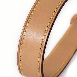 Close-up of vachetta leather handbag strap - honey color