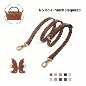 Pode incluir: Uma alça de bolsa de couro marrom com ferragens douradas, incluindo uma fivela e fechos. A alça é mostrada enrolada, com uma pequena bolsa no canto superior esquerdo. O texto "No Hole Punch Required" está acima.