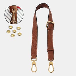 May include: A brown leather purse strap with gold-colored hardware, including a buckle and clasps. The strap has white stitching and is shown with additional gold eyelets and a close-up of a clasp attached to a purse.
