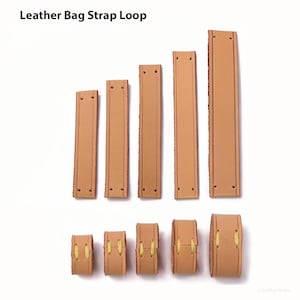 Peut inclure: Diverses boucles de sangle de sac en cuir beige. L'image présente des lanières rectangulaires avec des trous pré-percés et des boucles arrondies, toutes de couleur marron clair. Le texte "Leather Bag Strap Loop" est visible en haut.